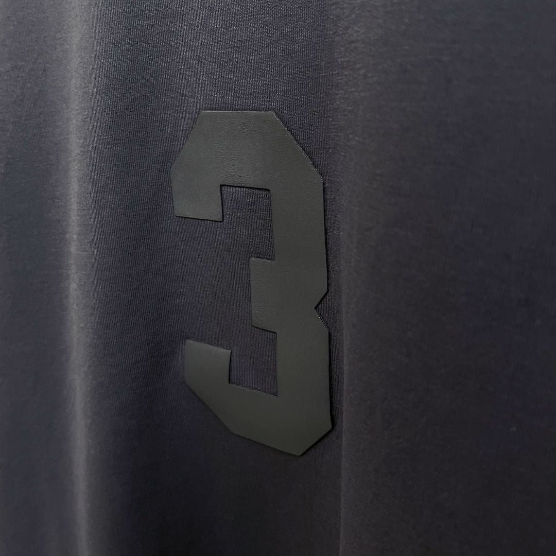 A grey oversized t-shirt featuring the number 3, showcasing luxury street style from the Indian brand Beyond Extremes.