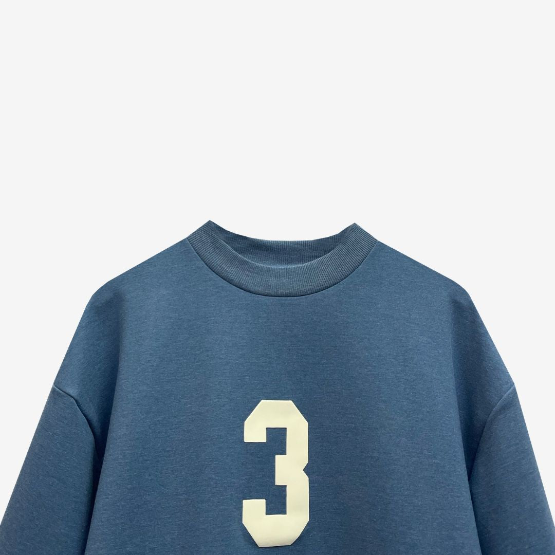 A blue oversized t-shirt featuring the number 3, showcasing luxury street style from the Indian brand Beyond Extremes.