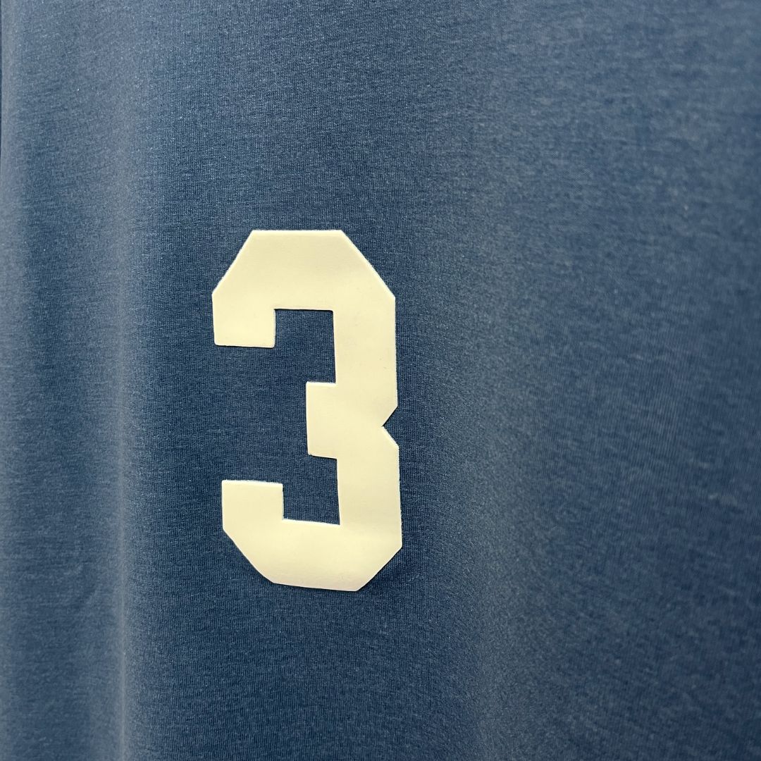 A blue oversized t-shirt featuring the number 3, showcasing luxury street style from the Indian brand Beyond Extremes.